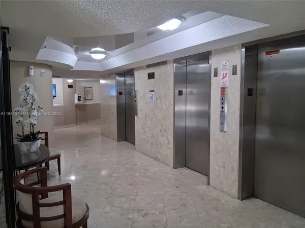a view of hallway with livingroom and stairs