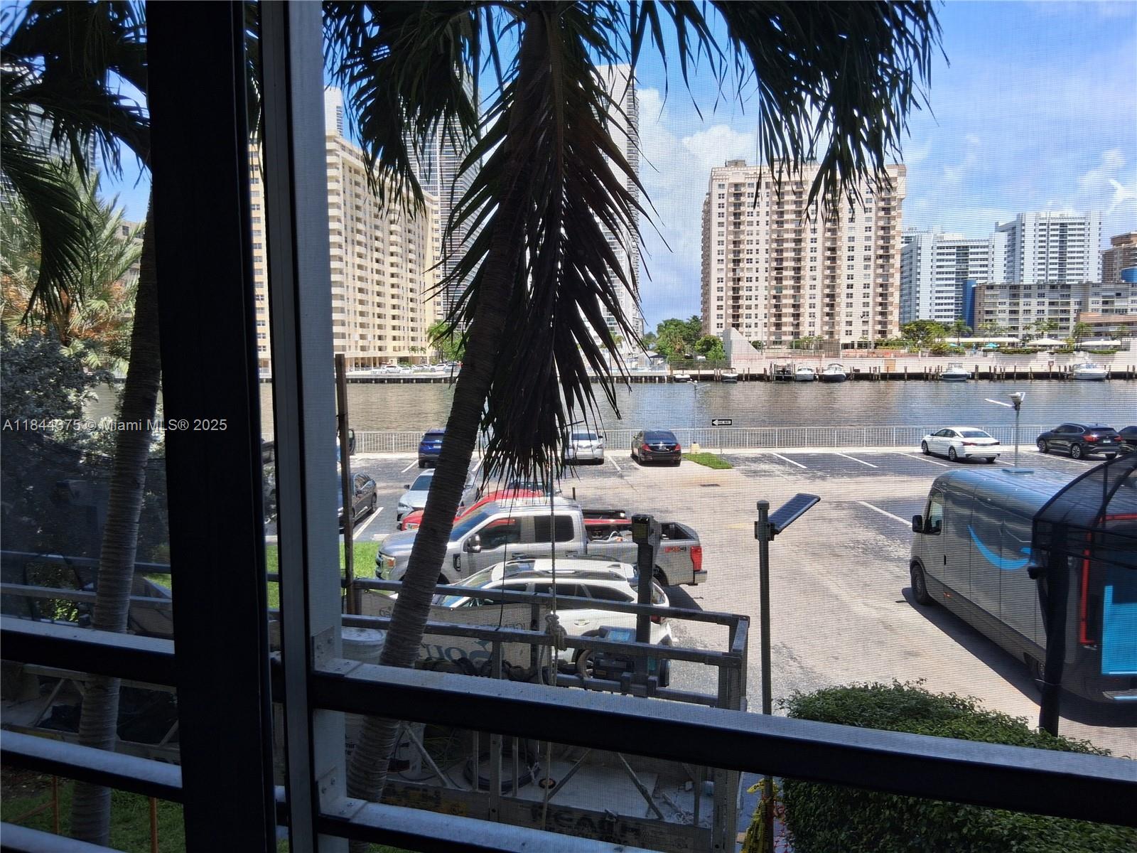 100 Golden Isles Drive, Unit 206 Hallandale Beach, FL 33009 - Photo 8 of 22 a view of a balcony with a tree