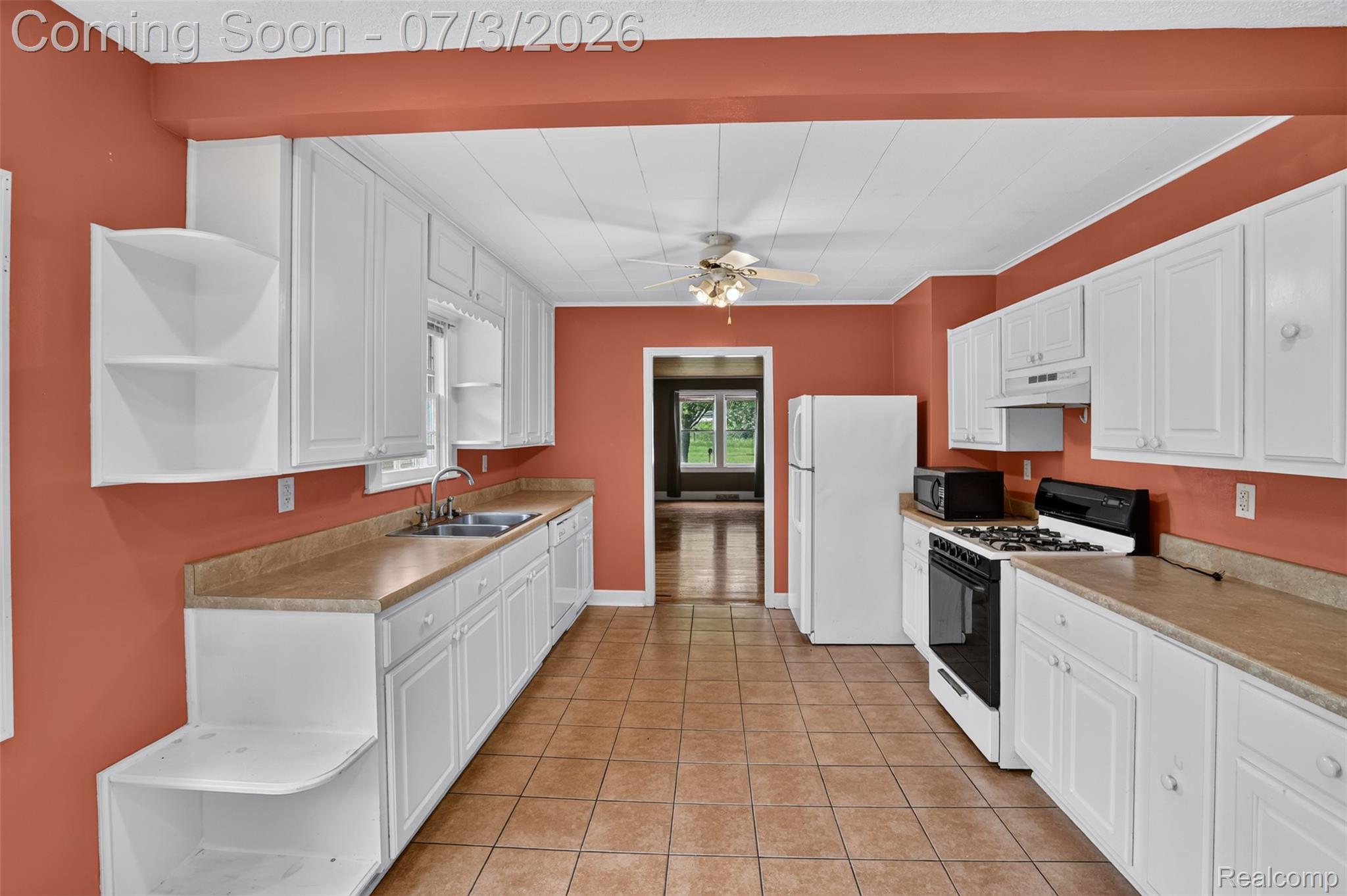 4322 Baker Road Bridgeport, MI 48722 - Photo 3 of 29 Kitchen featuring white cabinetry, light-toned countertops, and tile flooring