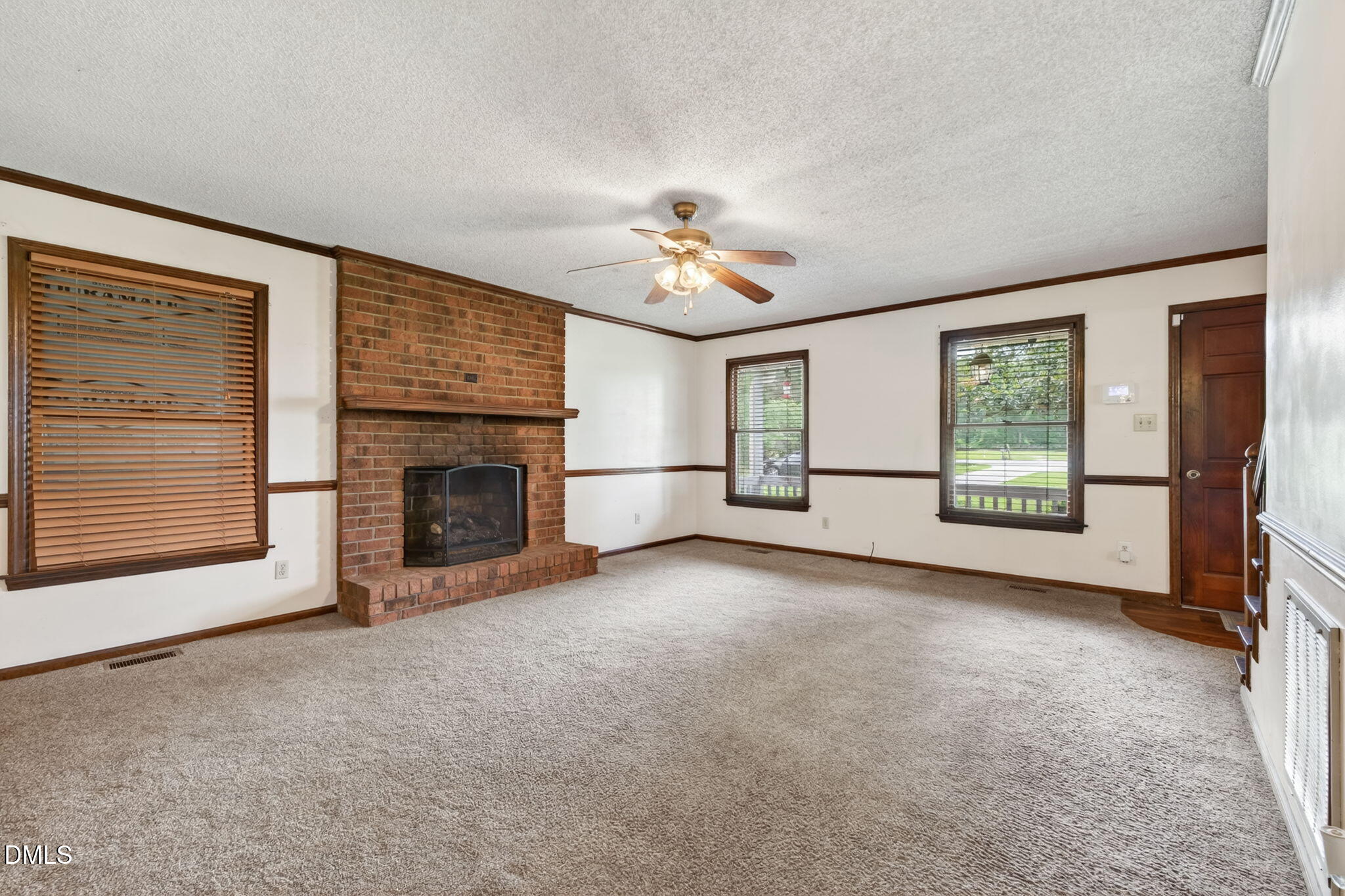 350 Grantham School Road Goldsboro, NC 27530 - Photo 6 of 49 an empty room with windows and fireplace