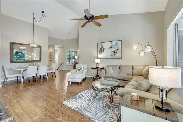 a living room with furniture a rug and a chandelier