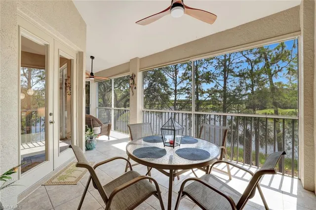 a balcony with table and chairs