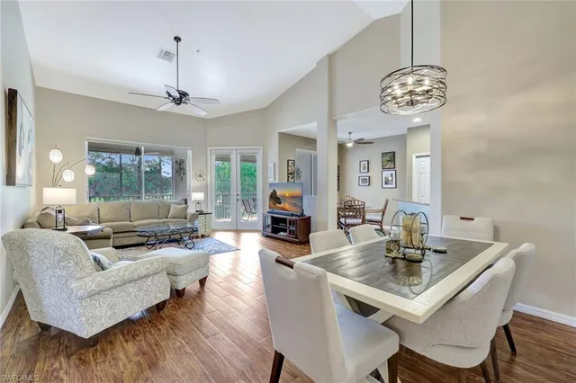 a view of a dining room with furniture wooden floor and a chandelier