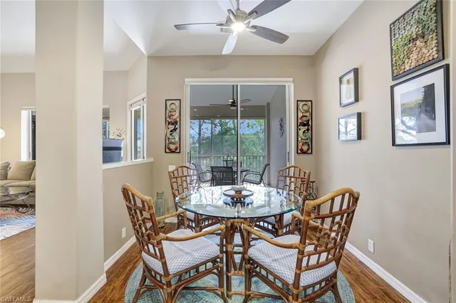 a dining room with furniture a chandelier and wooden floor