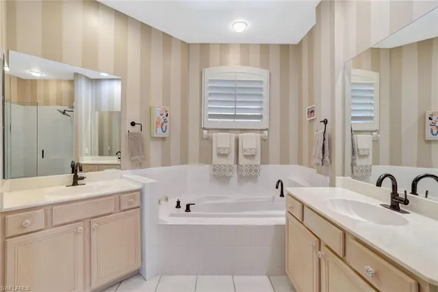 a bathroom with a tub sink and mirror