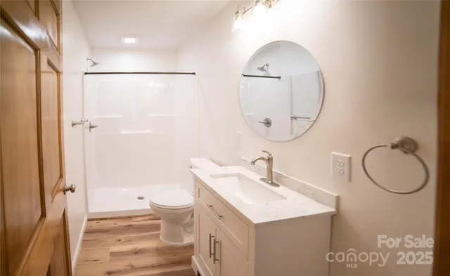 a bathroom with a sink a toilet and a mirror