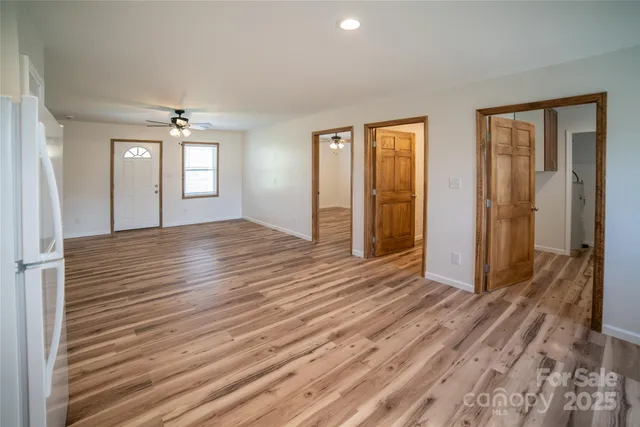 a view of wooden floor and windows in a room