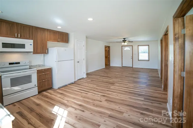 a kitchen with stainless steel appliances granite countertop a stove a sink and a refrigerator