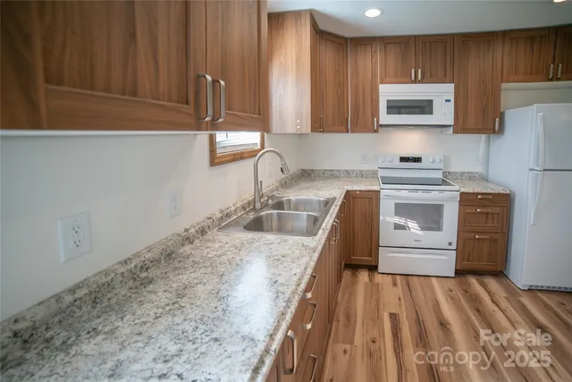 a kitchen with a sink a stove and cabinets