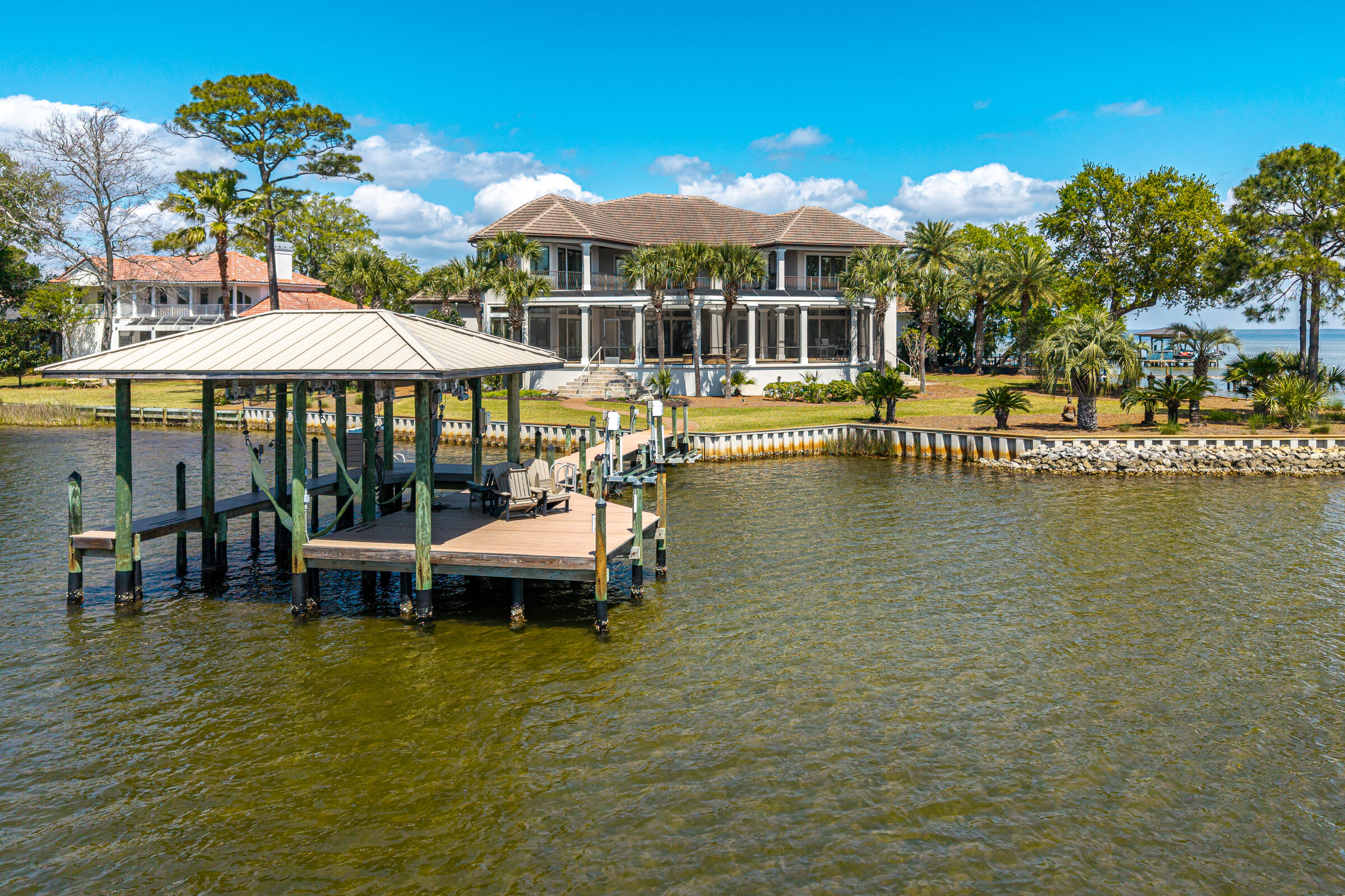 1806 Driftwood Point Road Santa Rosa Beach, FL 32459 - Photo 73 of 142 a view of a swimming pool with a table and chairs