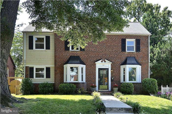 300 Dearborn Avenue Silver Spring, MD 20901 - Photo 1 of 30 a front view of a house with a yard and trees