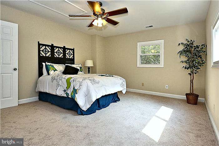 300 Dearborn Avenue Silver Spring, MD 20901 - Photo 2 of 30 a bedroom with a bed and a chandelier