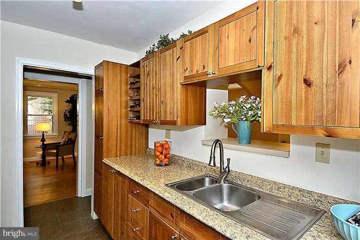 300 Dearborn Avenue Silver Spring, MD 20901 - Photo 11 of 30 a kitchen with stainless steel appliances granite countertop a sink and a wooden cabinets