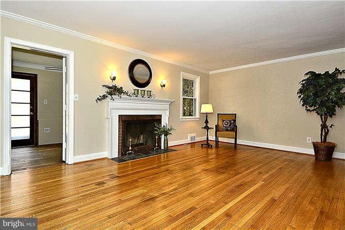 300 Dearborn Avenue Silver Spring, MD 20901 - Photo 12 of 30 a view of an empty room with a fireplace and wooden floor
