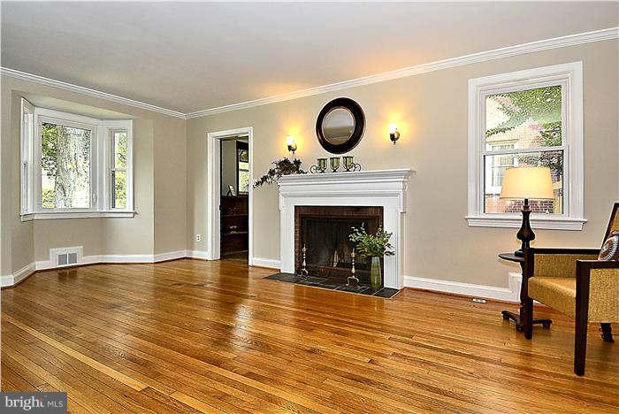300 Dearborn Avenue Silver Spring, MD 20901 - Photo 13 of 30 a view of an empty room with wooden floor a fireplace and a window