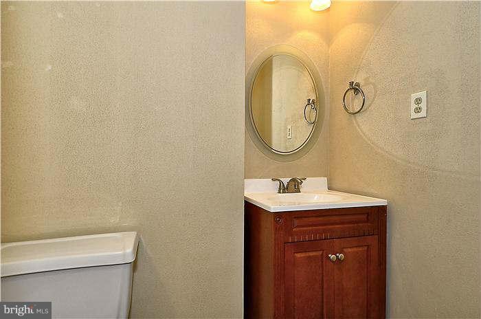 300 Dearborn Avenue Silver Spring, MD 20901 - Photo 16 of 30 a bathroom with a sink a toilet and a mirror