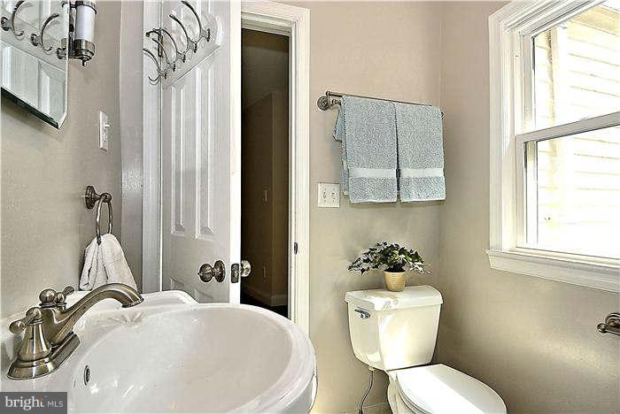300 Dearborn Avenue Silver Spring, MD 20901 - Photo 19 of 30 a bathroom with a toilet a sink and mirror