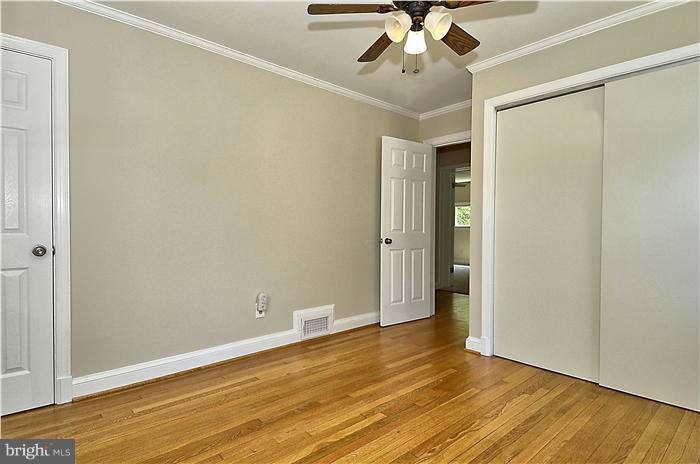 300 Dearborn Avenue Silver Spring, MD 20901 - Photo 23 of 30 an empty room with wooden floor and fan