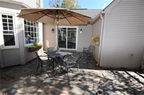 471 Bay Road Amherst, MA 01002 - Photo 26 of 30 a view of a patio with table and chairs under an umbrella