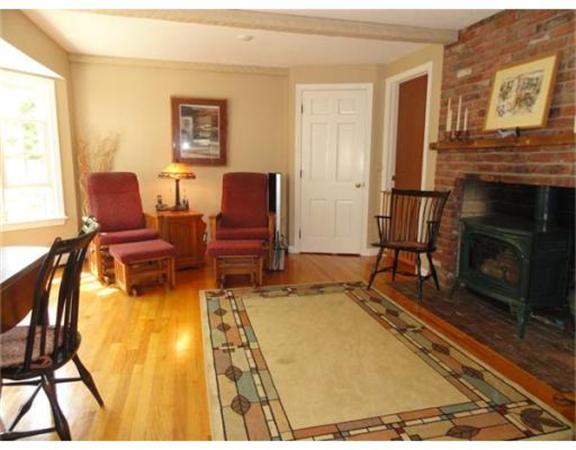 471 Bay Road Amherst, MA 01002 - Photo 8 of 30 a living room with furniture a flat screen tv and a fireplace