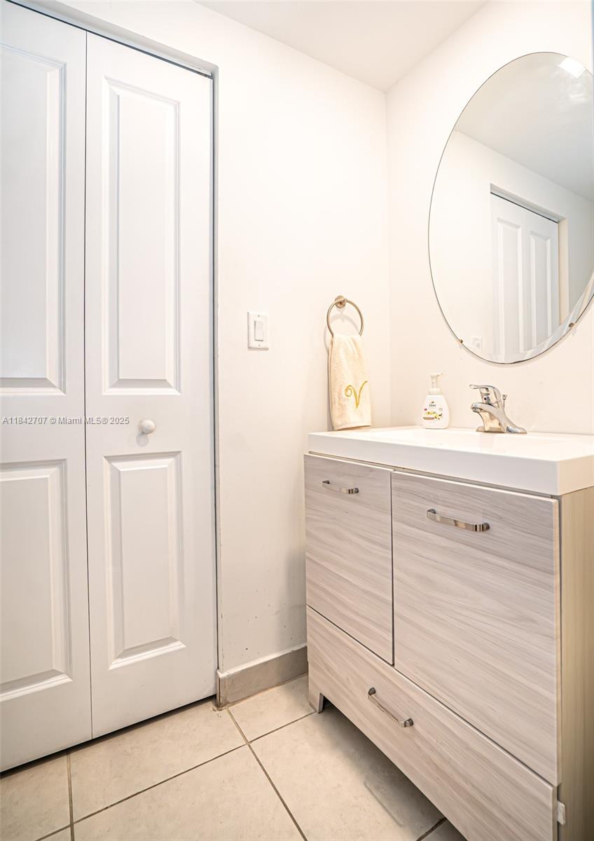 10118 Southwest 231st Lane Miami, FL 33190 - Photo 14 of 19 a bathroom with a sink vanity and a mirror