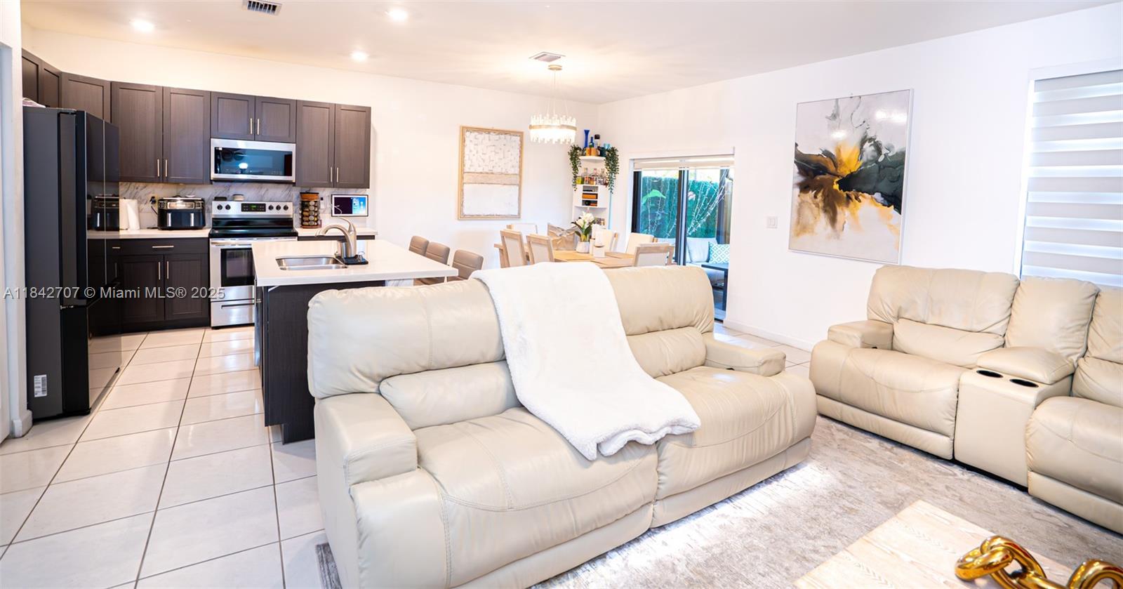 10118 Southwest 231st Lane Miami, FL 33190 - Photo 6 of 19 a living room with stainless steel appliances furniture and a kitchen view