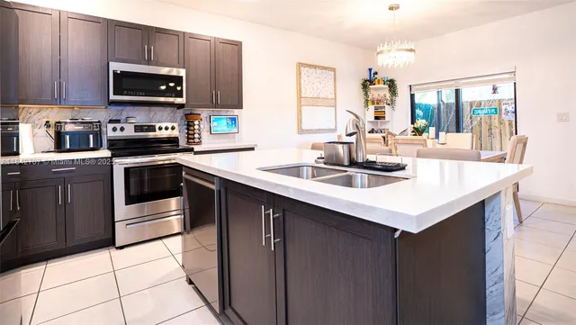 a kitchen with granite countertop a sink and cabinets