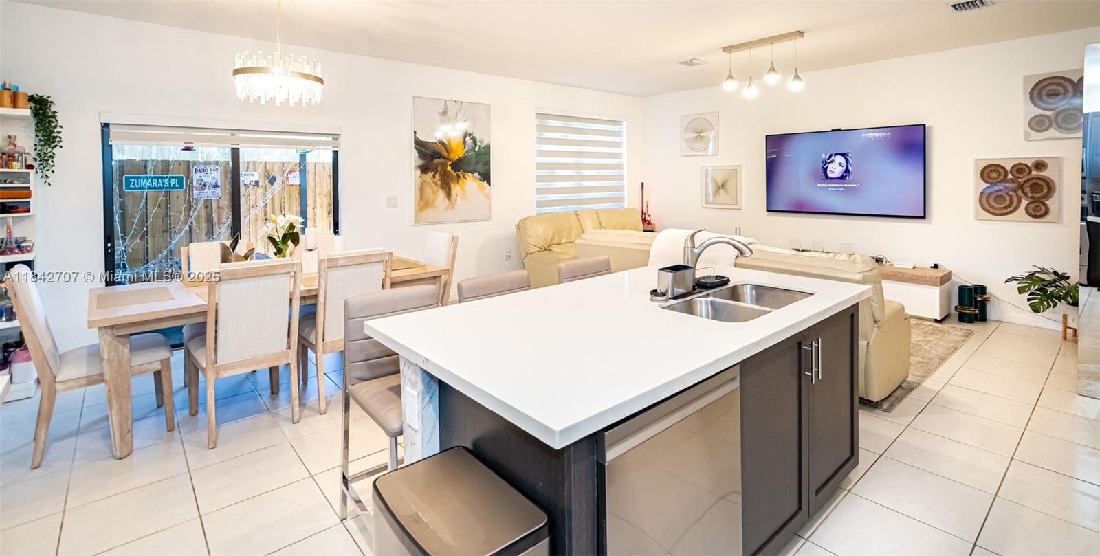 10118 Southwest 231st Lane Miami, FL 33190 - Photo 8 of 19 a view of kitchen island a sink a table and chairs