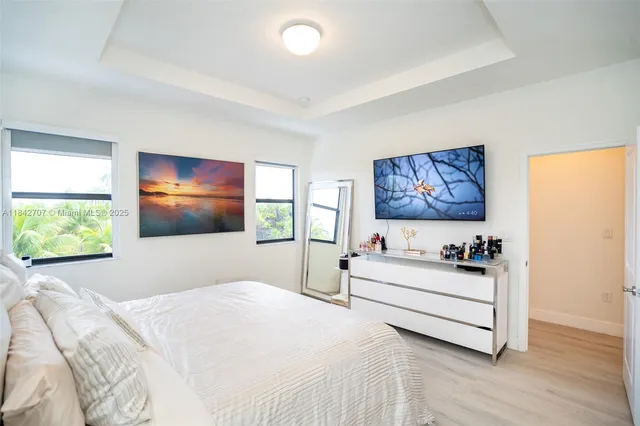 a bedroom with a bed and a painting on the wall