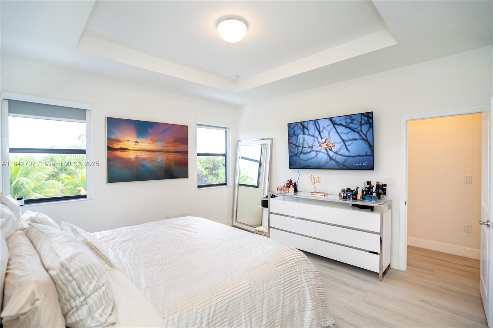 10118 Southwest 231st Lane Miami, FL 33190 - Photo 10 of 19 a bedroom with a bed and a painting on the wall