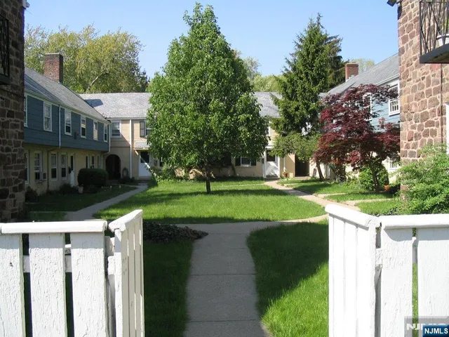 a view of a house with a yard and plants