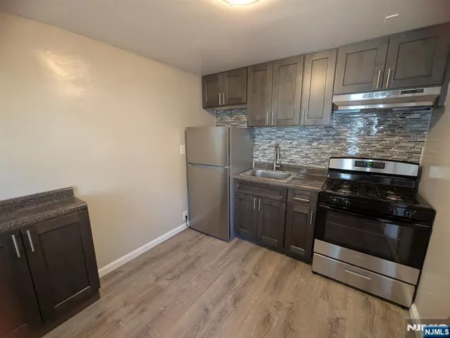 a kitchen with a stove and a refrigerator