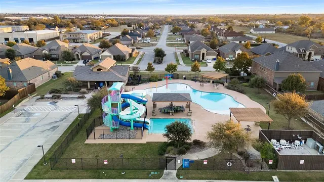 an aerial view of residential houses with outdoor space