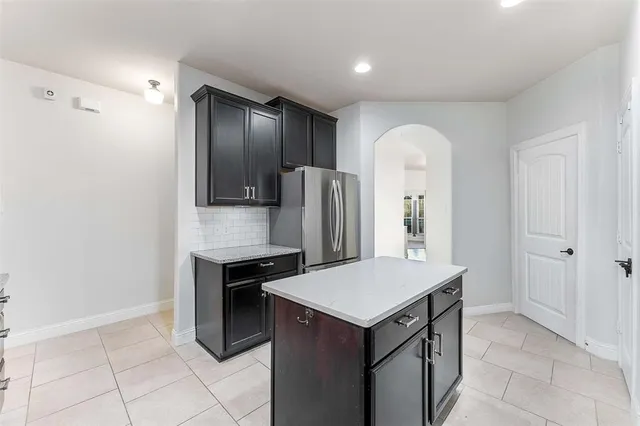 a kitchen with stainless steel appliances a refrigerator and a stove