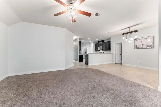 a view of a kitchen with a chandelier fan and a kitchen view
