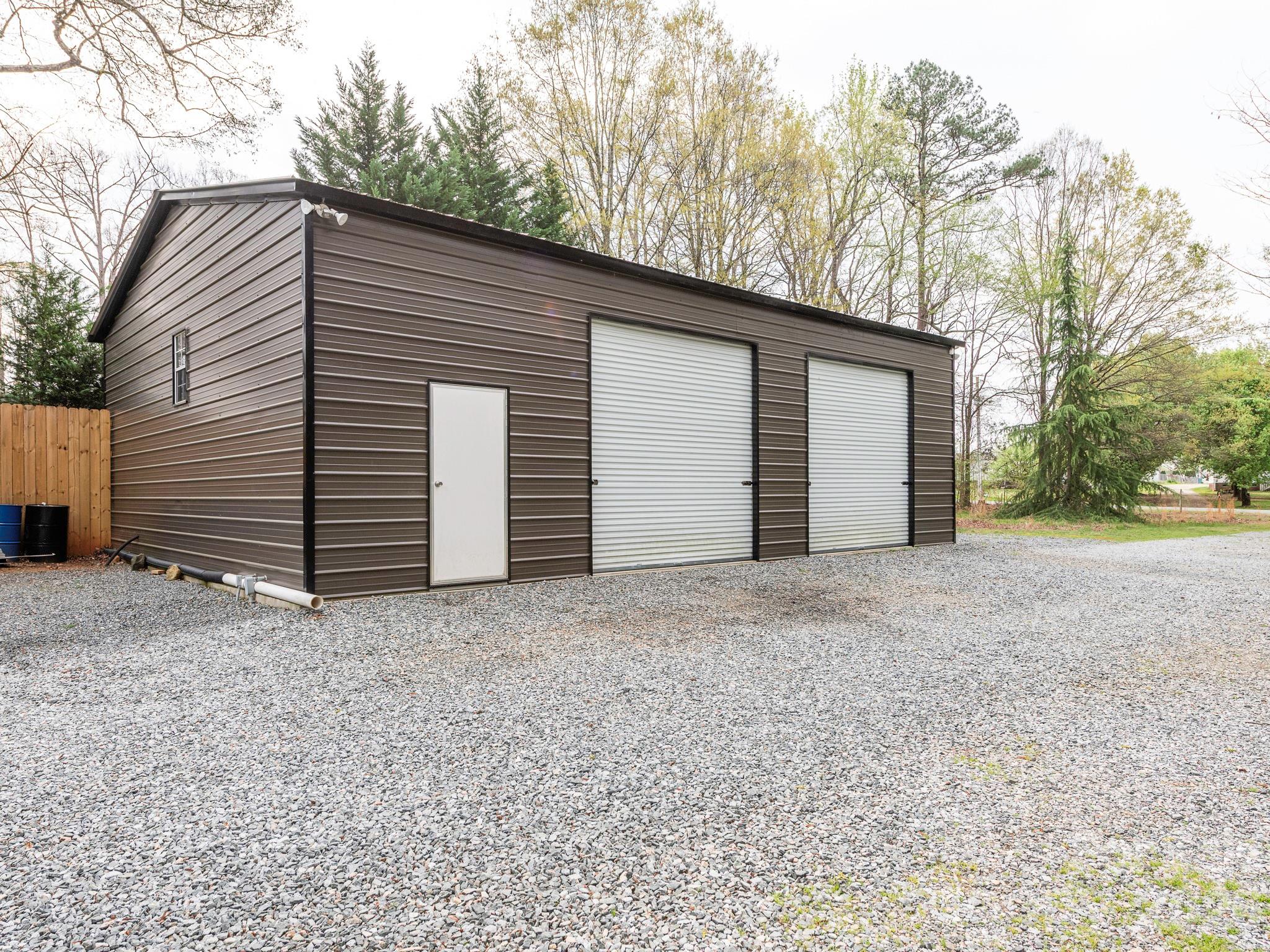 8202 Karriker Road Kannapolis, NC 28081 - Photo 11 of 12 a view of a house with a yard and garage
