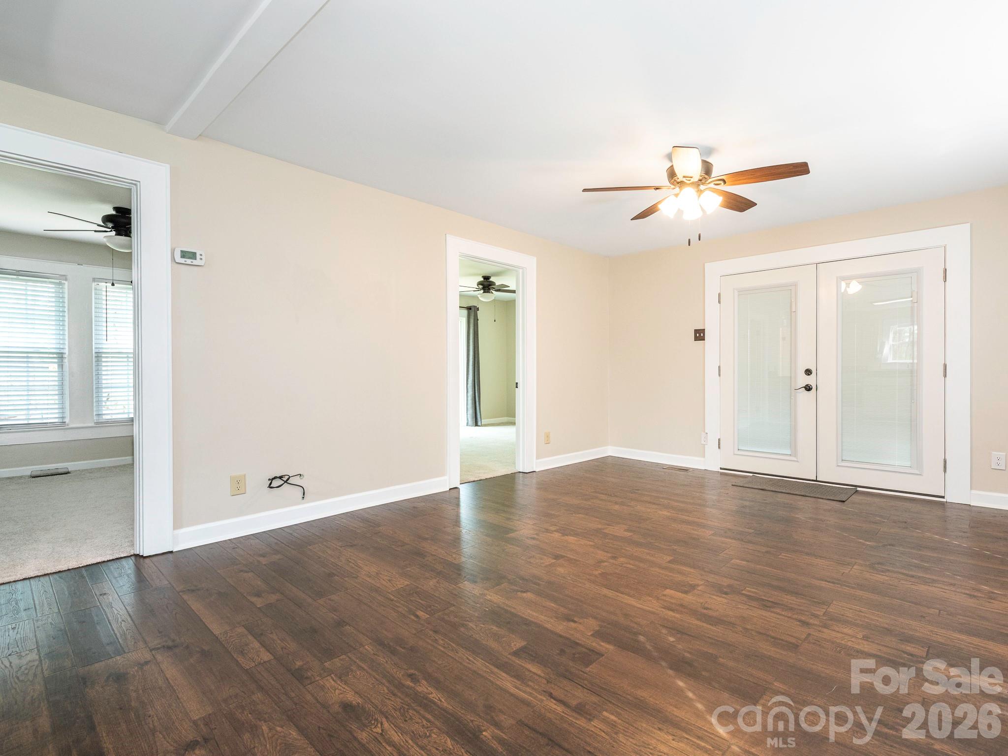 8202 Karriker Road Kannapolis, NC 28081 - Photo 6 of 12 an empty room with wooden floor and windows