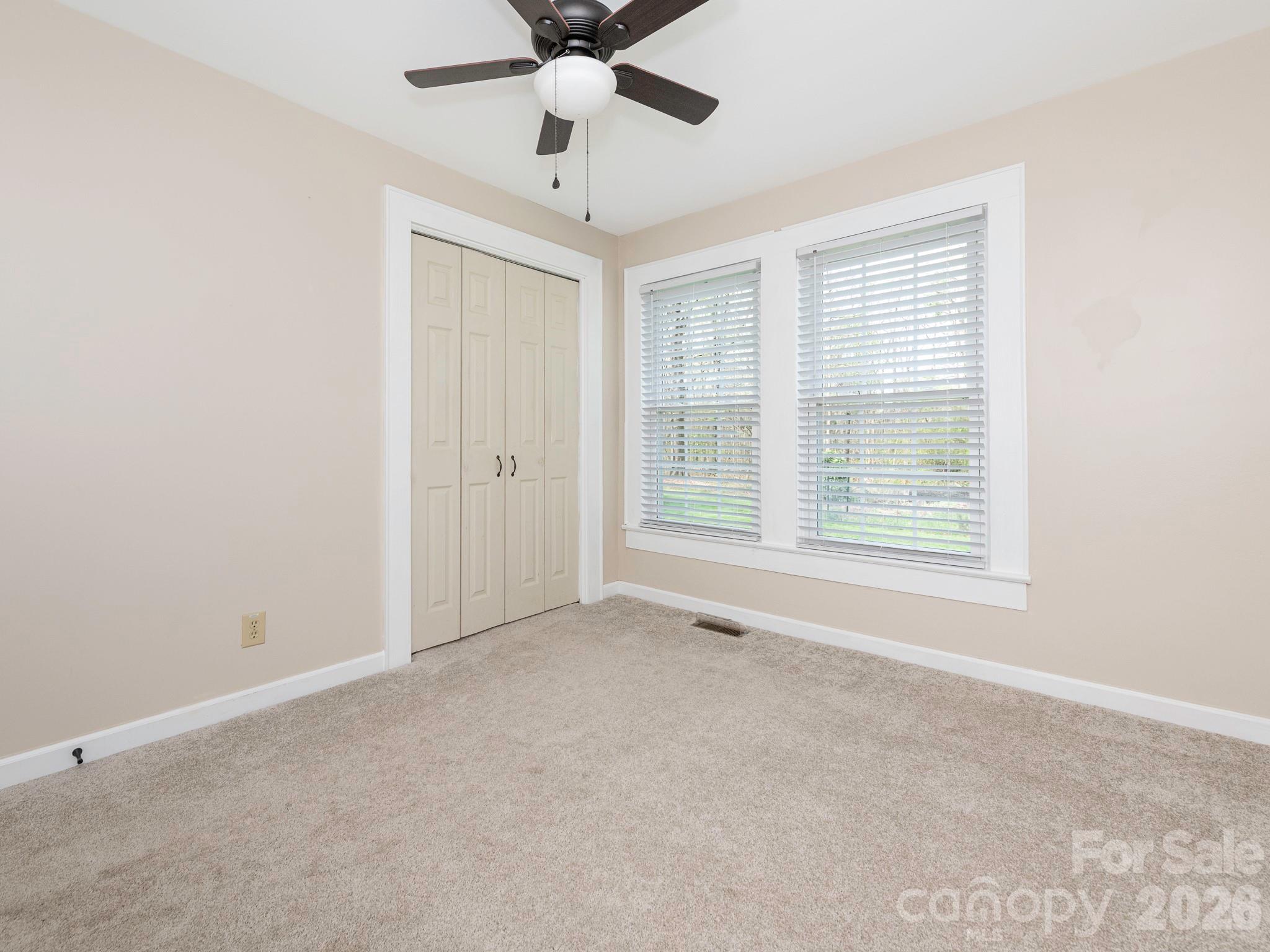8202 Karriker Road Kannapolis, NC 28081 - Photo 7 of 12 an empty room with windows and fan