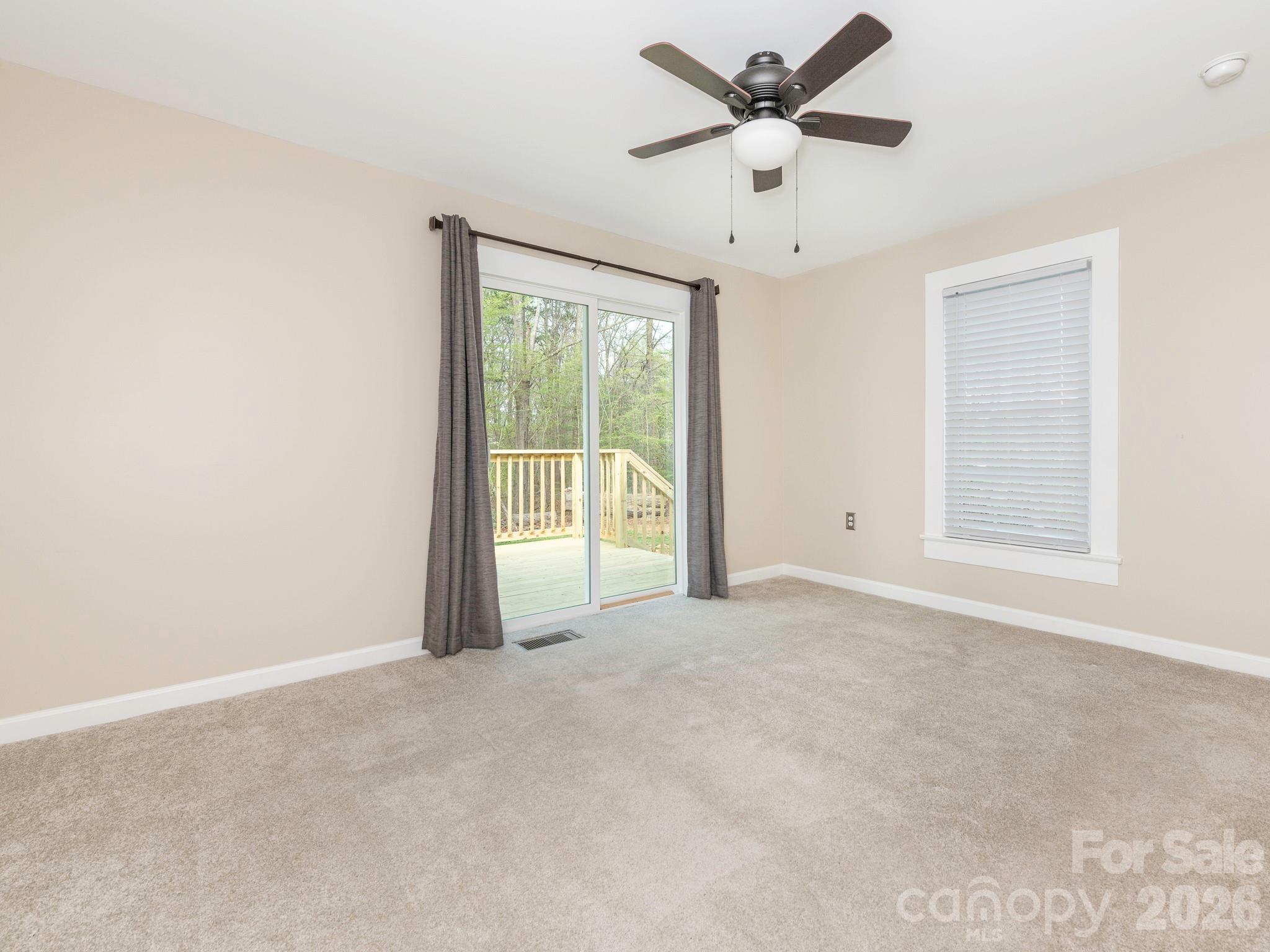 8202 Karriker Road Kannapolis, NC 28081 - Photo 8 of 12 a view of a livingroom with a ceiling fan and window