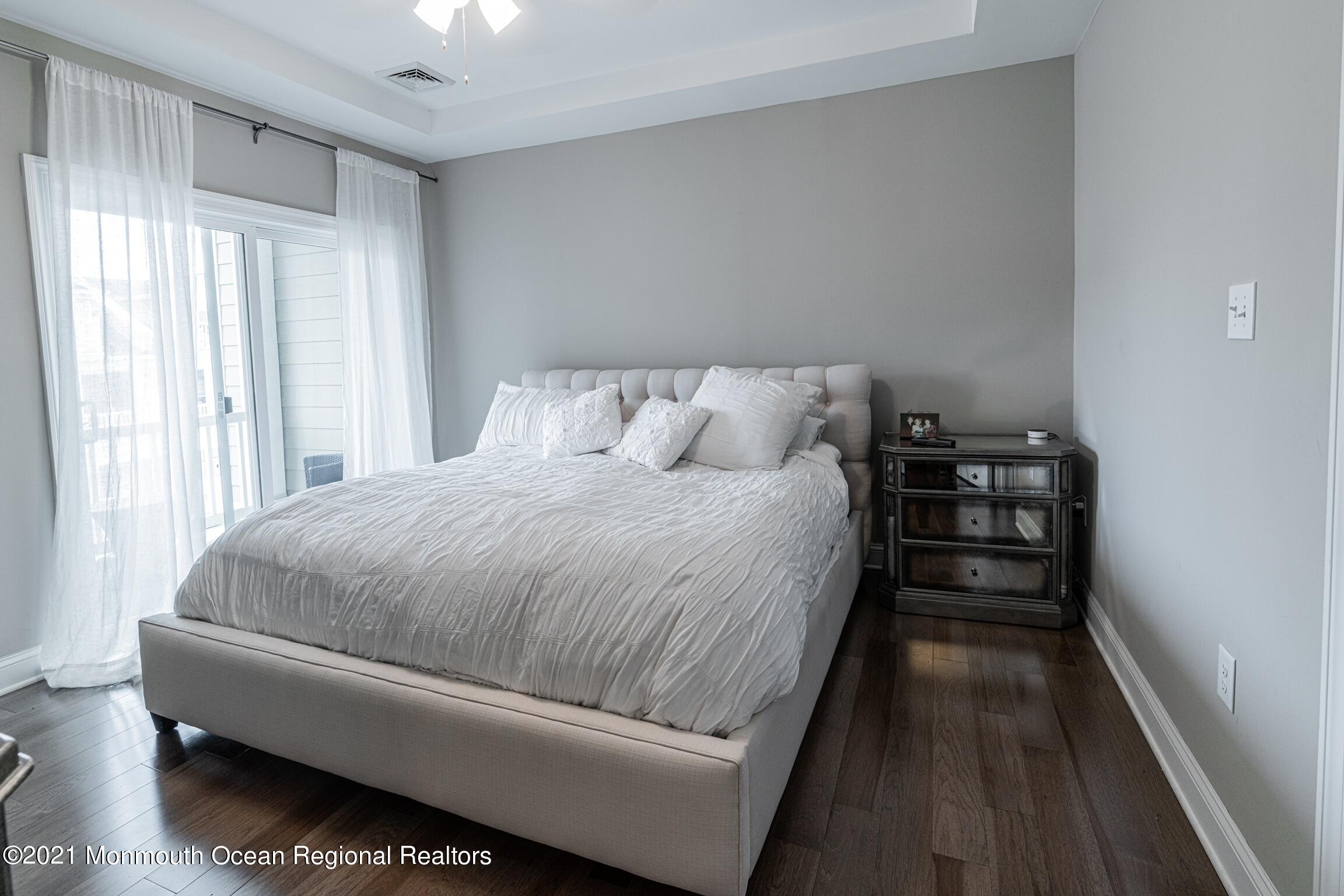 67 Ocean Terrace Long Branch, NJ 07740 - Photo 13 of 20 a bed room with a bed and a wooden floor