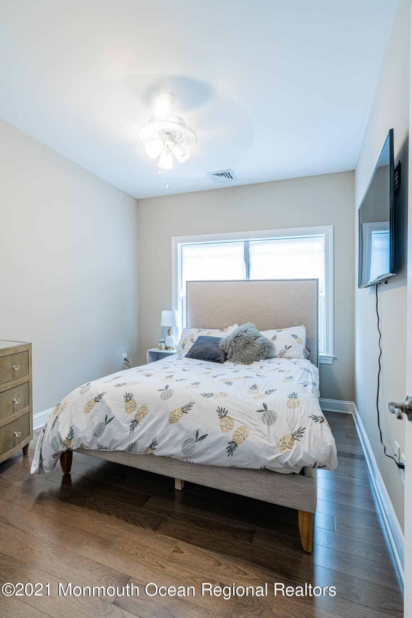 67 Ocean Terrace Long Branch, NJ 07740 - Photo 15 of 20 a bedroom with a bed and a flat screen tv