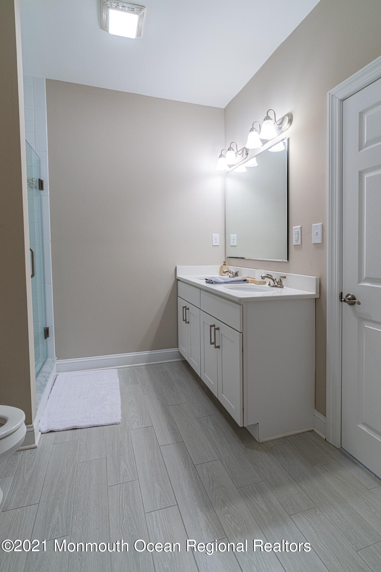 67 Ocean Terrace Long Branch, NJ 07740 - Photo 19 of 20 a bathroom with a double vanity sink and a mirror