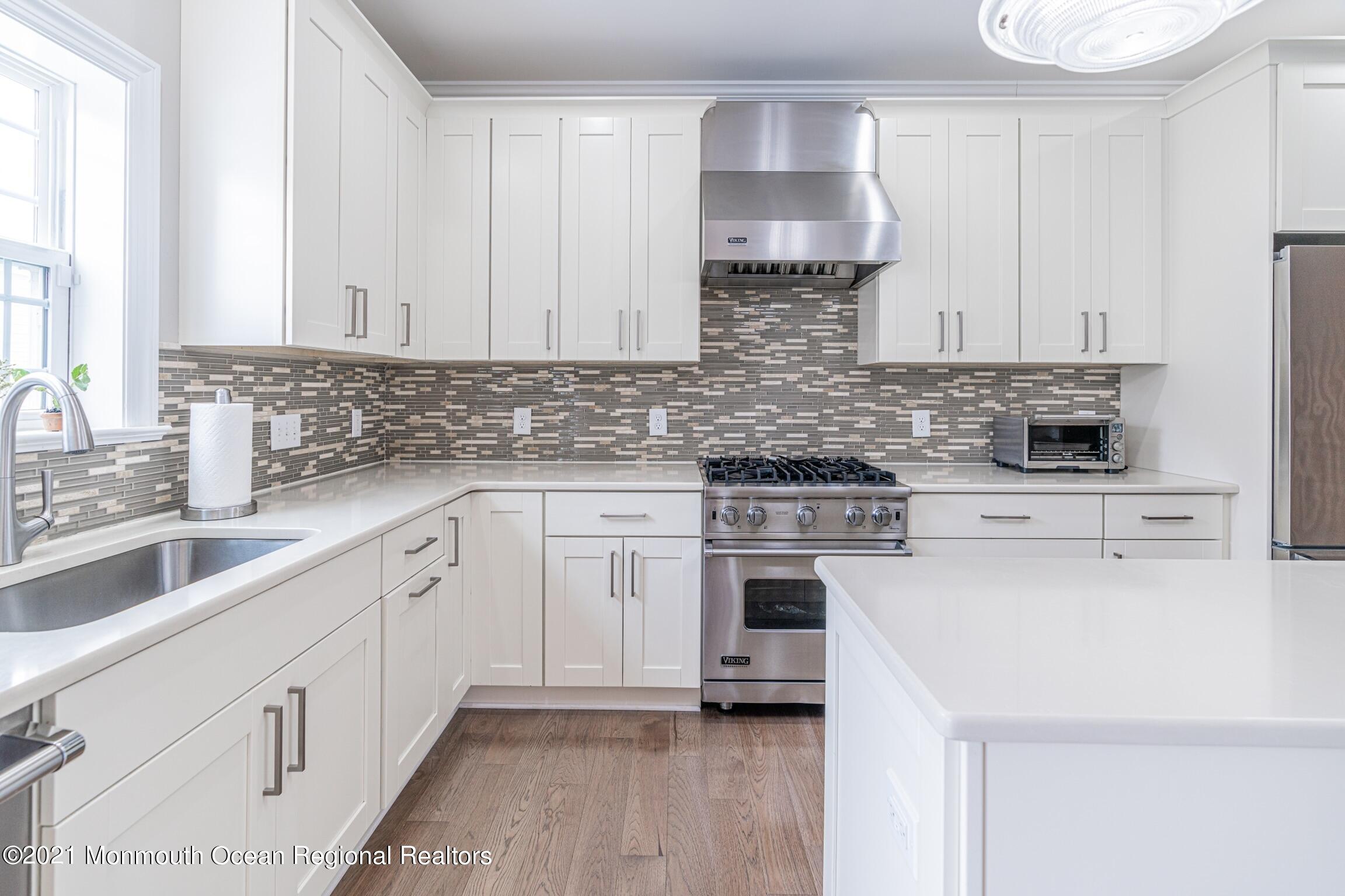 67 Ocean Terrace Long Branch, NJ 07740 - Photo 5 of 20 a kitchen with a sink cabinets and stainless steel appliances