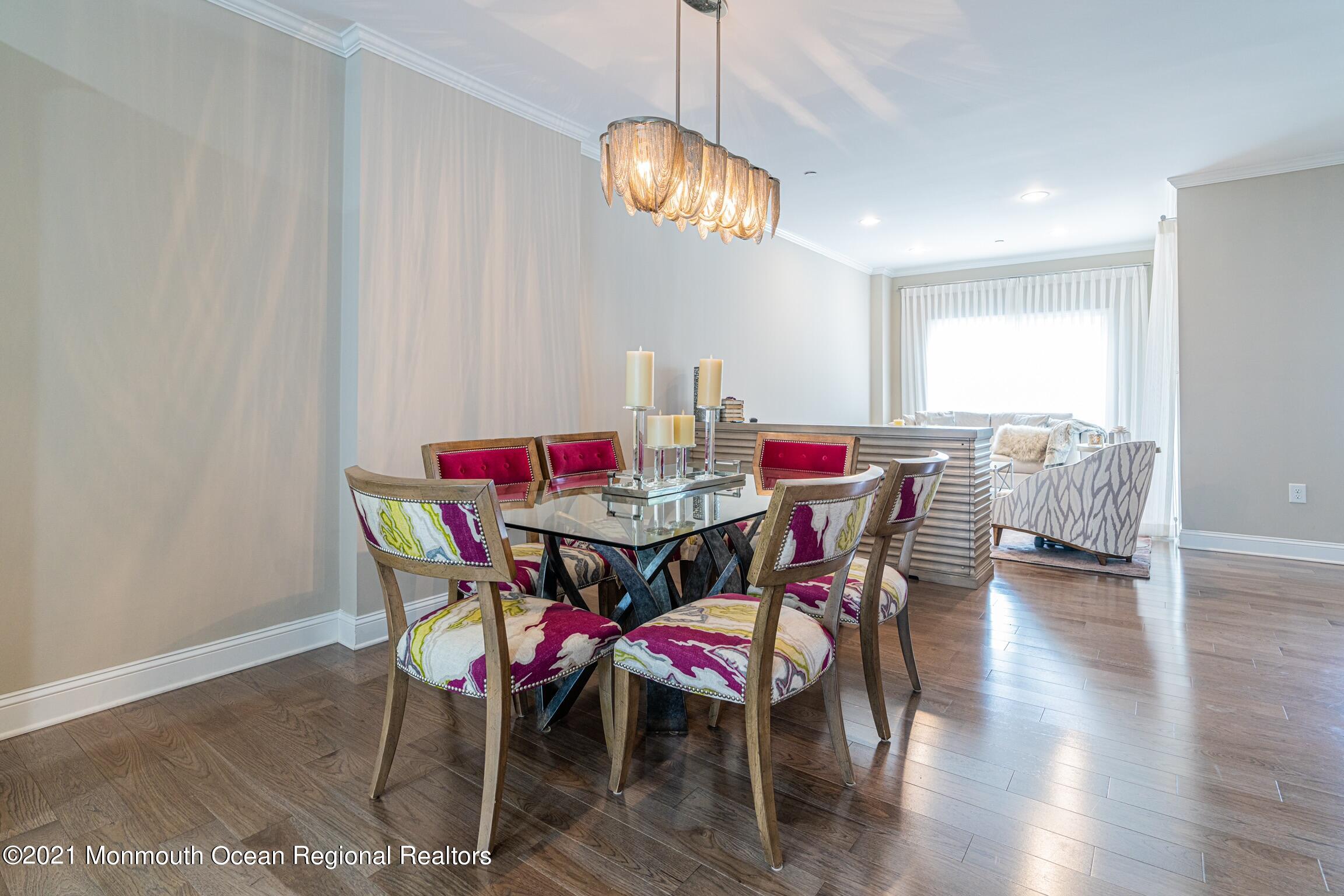 67 Ocean Terrace Long Branch, NJ 07740 - Photo 8 of 20 a dining room with furniture a chandelier and wooden floor