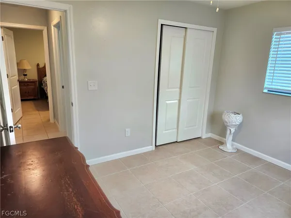 a view of a room with wooden floor and bathroom view