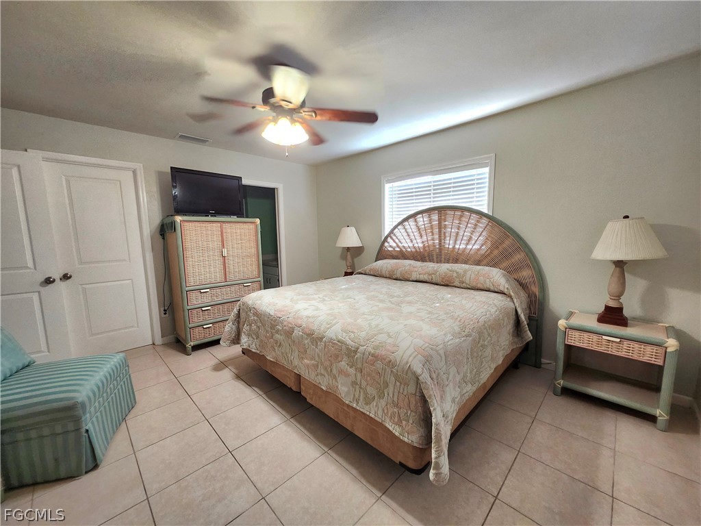 12938 5th Street Fort Myers, FL 33905 - Photo 15 of 25 a bedroom with a bed and a chandelier