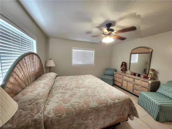 a bedroom with a bed couches and flat screen tv