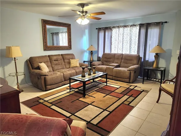 a living room with furniture and a chandelier