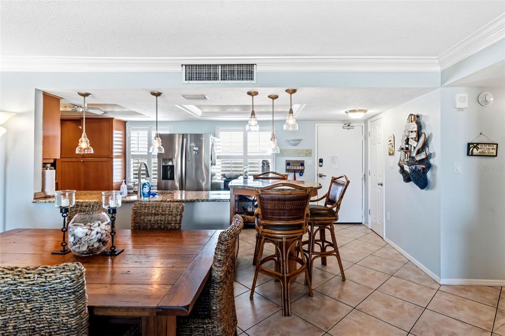 6300 Midnight Pass Road, Unit 708 Sarasota, FL 34242 - Photo 14 of 49 a dining room with furniture and wooden floor