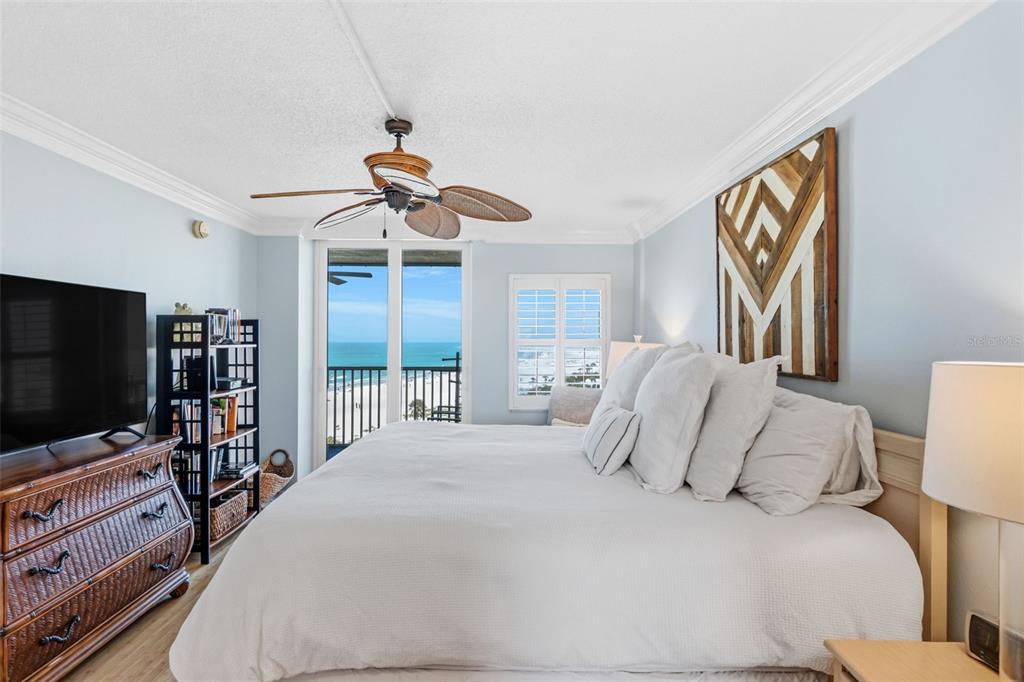 6300 Midnight Pass Road, Unit 708 Sarasota, FL 34242 - Photo 29 of 49 a bedroom with a bed and a flat screen tv